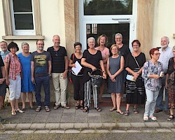 Besucher beim Gruppenbild mit Schule